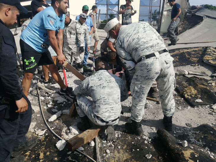 Lực lượng chức năng đang làm nhiệm vụ giải cứu - Ảnh: REUTERS
