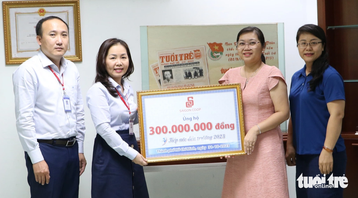 Bà Trương Phan Hoàng Thy (thứ hai, từ trái qua) - phó chủ tịch Công đoàn Liên hiệp Hợp tác xã Thương mại TP.HCM (Saigon Co.op) - trao 300 triệu đồng ủng hộ chương trình Tiếp sức đến trường 2023 của báo Tuổi Trẻ - Ảnh: B.MINH