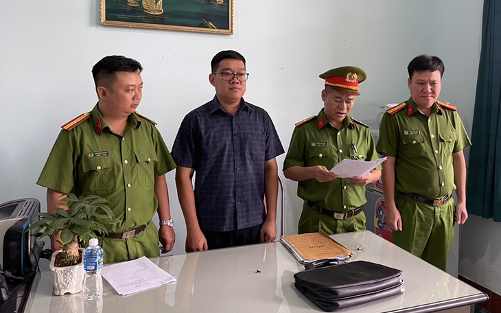 Cơ quan điều tra tống đạt quyết định khởi tố bị can và thi hành lệnh cấm đi khỏi nơi cư trú đối với Nguyễn Sơn Hải, phó giám đốc Trung tâm đăng kiểm xe cơ giới 60-02S - Ảnh: Công an cung cấp