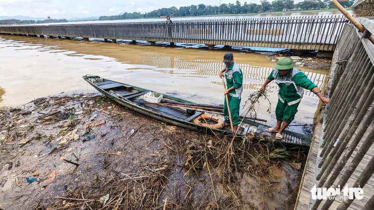Sáng 21-11, công nhân của Công ty CP Môi trường và Công trình đô thị Huế vẫn tích cực dọn rác để lại trên sông Hương sau trận lụt hôm 15-11  - Ảnh: NHẬT LINH