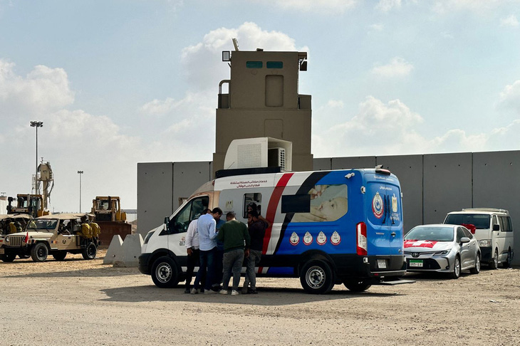 Xe cứu thương đợi ở cửa khẩu Rafah của Ai Cập chờ đưa người bị thương từ Dải Gaza đến bệnh viện dã chiến ở Ai Cập - Ảnh: AFP