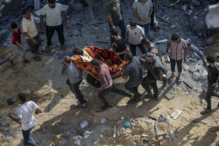 Người dân Gaza đưa nạn nhân do không kích của Israel vào trại Jabalia đến bệnh viện - Ảnh: EPA