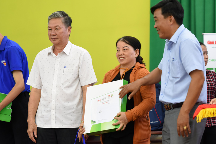 Bà Đào Thị Cam vui mừng nhận vốn vay không lãi suất tại chương trình Tiếp sức nhà nông - Ảnh: AN BÌNH
