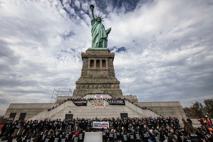 Các thành viên nhóm &quot;Tiếng nói của người Do Thái vì hòa bình&quot; biểu tình trước tượng Nữ thần Tự do ở New York (Mỹ) vào ngày 6-11 để kêu gọi ngừng bắn ở Dải Gaza - Ảnh: NEW YORK TIMES