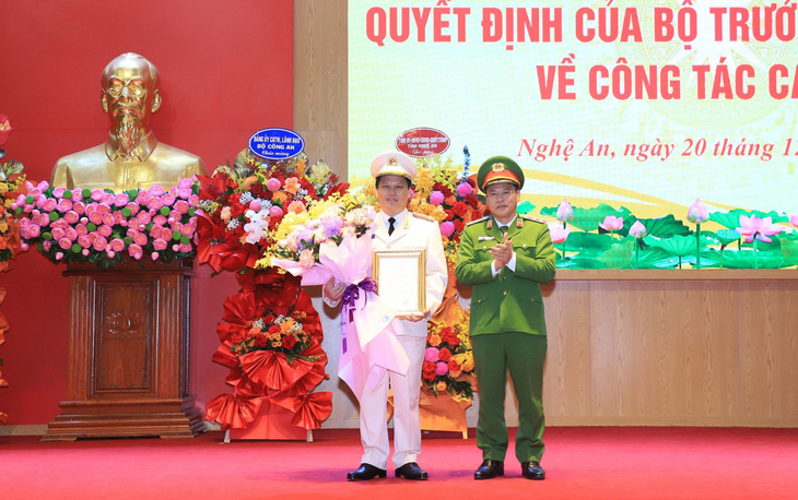Trung tướng Nguyễn Văn Long - thứ trưởng Bộ Công an - trao quyết định điều động bổ nhiệm của bộ trưởng Bộ Công an cho đại tá Bùi Quang Thanh - Ảnh: DOÃN HÒA