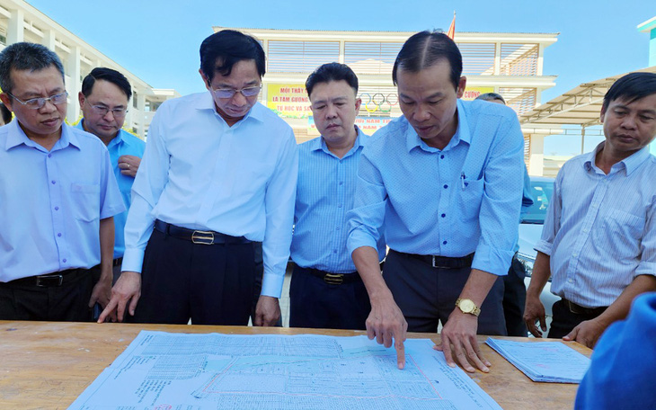 Ông Võ Văn Phi, phó chủ tịch UBND tỉnh Đồng Nai (thứ ba từ trái qua), nghe báo cáo các vị trí chưa giải phóng mặt bằng ở dự án cao tốc Biên Hòa - Vũng Tàu - Ảnh: H.M.
