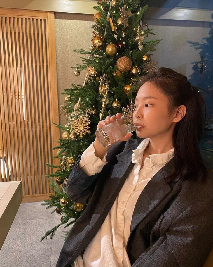 Ở một góc ảnh khác, nữ idol cầm ly uống nước và khoe không khí Giáng sinh bên cây thông. Cư dân mạng kiểu: 