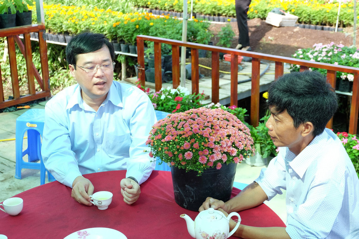 Bí thư Tỉnh ủy Đồng Tháp Lê Quốc Phong (trái) thăm nông dân, nghe tình hình cung ứng hoa kiểng cho festival và vụ hoa Tết - Ảnh: ĐẶNG TUYẾT