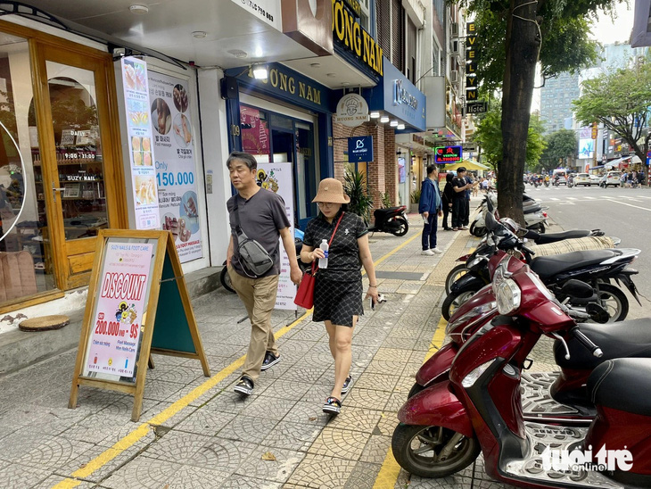 Vỉa hè gần chợ Hàn nơi có đông khách du lịch được kẻ vạch chia ba để hài hòa lợi ích “kinh tế vỉa hè” và phục vụ người đi bộ - Ảnh: TRƯỜNG TRUNG