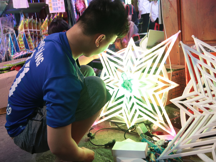 Một nhân viên đang chạy thử điện cho ngôi sao để kiểm tra độ chiếu sáng và màu sắc - Ảnh: MINH CHÂU