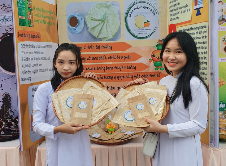Em Hà Thị Yến Thơ (phải) và Phan Hồng Ngân cùng ý tưởng khởi nghiệp bánh tráng quýt hồng - Ảnh: NVCC