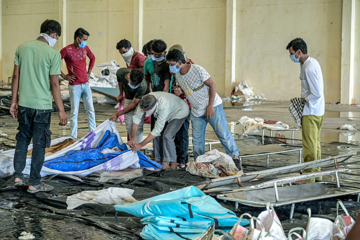 Thân nhân đang tìm kiếm thi thể của các nạn nhân trong vụ tai nạn đường sắt ở bang Odisha, miền đông Ấn Độ hôm 2-6 - Ảnh: NEW YORK TIMES
