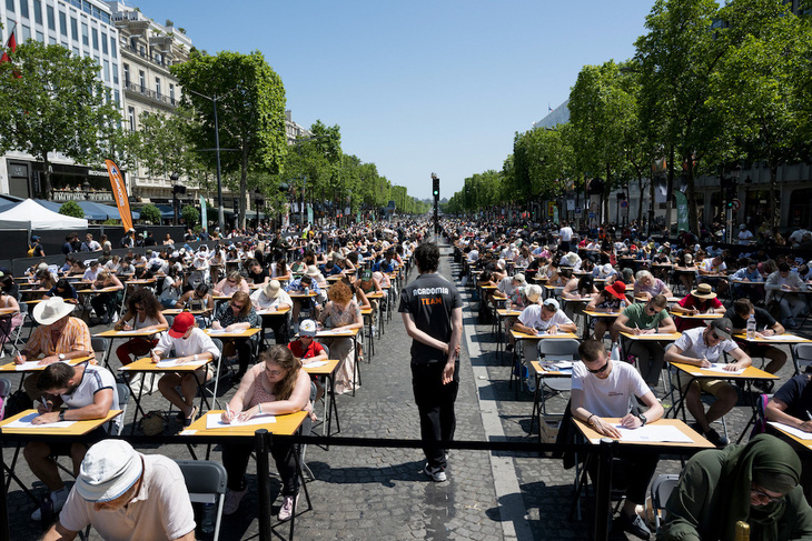 Lớp học khổng lồ. Nhiều người tham dự sự kiện phá kỷ lục “Lớp học viết chính tả lớn nhất thế giới” ở thủ đô Paris của Pháp ngày 4-6. Trong ảnh, đại lộ Champs-Elysees biến thành một lớp học khổng lồ. Ảnh: AFP