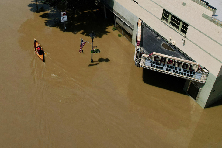Một người đi xuồng trên con phố ngập nước do mưa bão gần đây ở thành phố Montpelier, bang Vermont, Mỹ ngày 11-7 - Ảnh: REUTERS