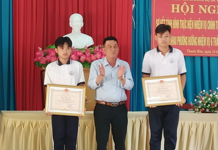 Đại diện lãnh đạo UBND thị xã Cai Lậy trao bằng khen cho hai học sinh - Ảnh: H.T.