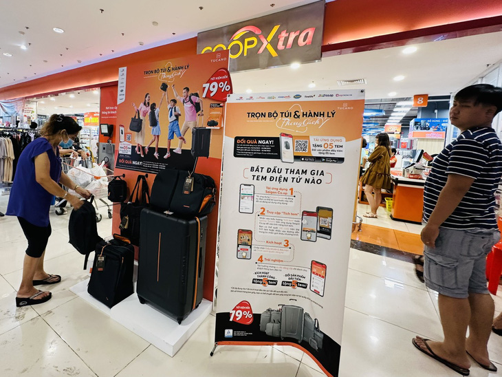 Khách hàng mua sắm tại các siêu thị thuộc Saigon Co.op, được tích tem và đổi lấy bộ túi và vali du lịch phong cách Ý làm bằng chất liệu tái chế - Ảnh: MỘC MIÊN