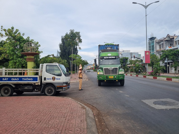 Cảnh sát giao thông tỉnh Bình Định kiểm tra các xe chở dăm gỗ - Ảnh: ĐẠT NGUYỄN