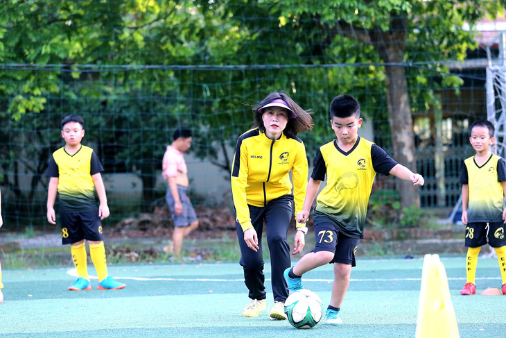 Ngoc Cham and her children at the community football center she founded.  Photo: DUC KHUE