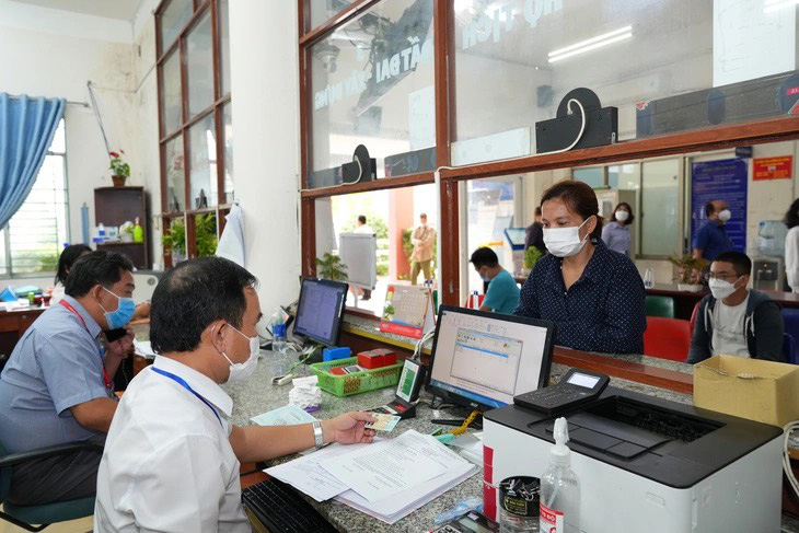 Cán bộ công chức UBND phường Bình Hưng Hòa A (quận Bình Tân, TP.HCM) giải quyết thủ tục hành chính cho người dân - Ảnh: HỮU HẠNH