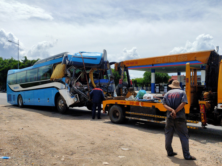 Kéo chiếc xe khách chở đoàn từ thiện gặp tai nạn trên cao tốc Nha Trang - Cam Lâm ra khỏi hiện trường - Ảnh: TRẦN HOÀI