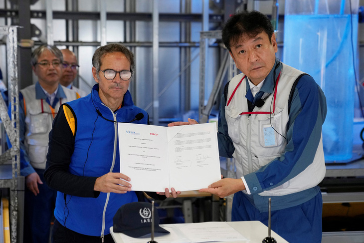 Tổng giám đốc IAEA Rafael Mariano Grossi (trái) và Chủ tịch TEPCO Tomoaki Kobayakawa - Ảnh: REUTERS 