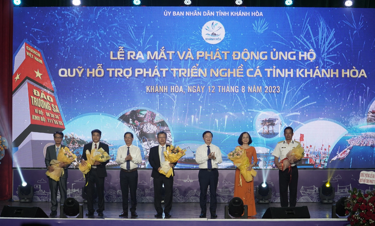Phó thủ tướng Trần Hồng Hà và chủ tịch UBND tỉnh Khánh Hòa tặng hoa cho hội đồng quản lý Quỹ hỗ trợ phát triển nghề cá Khánh Hòa, nguồn quỹ được kỳ vọng để phát triển kinh tế biển ở Trường Sa - Ảnh: TRẦN HƯỚNG