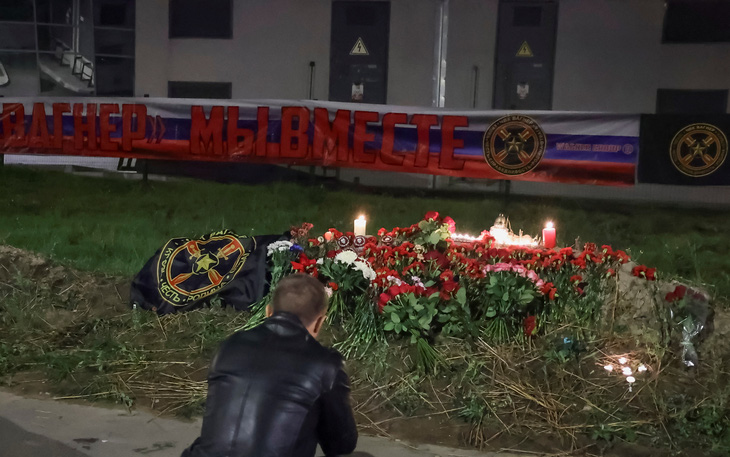 Một người dân St. Petersburg đứng trước điểm tưởng niệm ông Prigozhin tại thành phố này - Ảnh: REUTERS