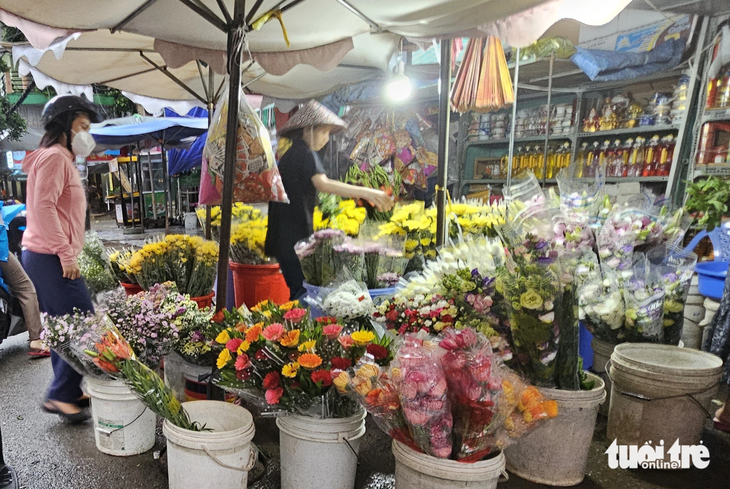 Giá nhiều loại hoa dịp rằm tháng bảy đã tăng so với ngày thường. Trong ảnh: Khách mua hoa tại cửa hàng ở quận Bình Thạnh vào chiều 30-8 - Ảnh: N.TRÍ