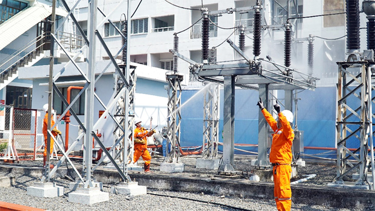 Công nhân Công ty Lưới điện cao thế xử lý bụi bẩn bám ở các chuỗi sứ và thiết bị trong trạm biến áp - Ảnh: Hoàng Tâm