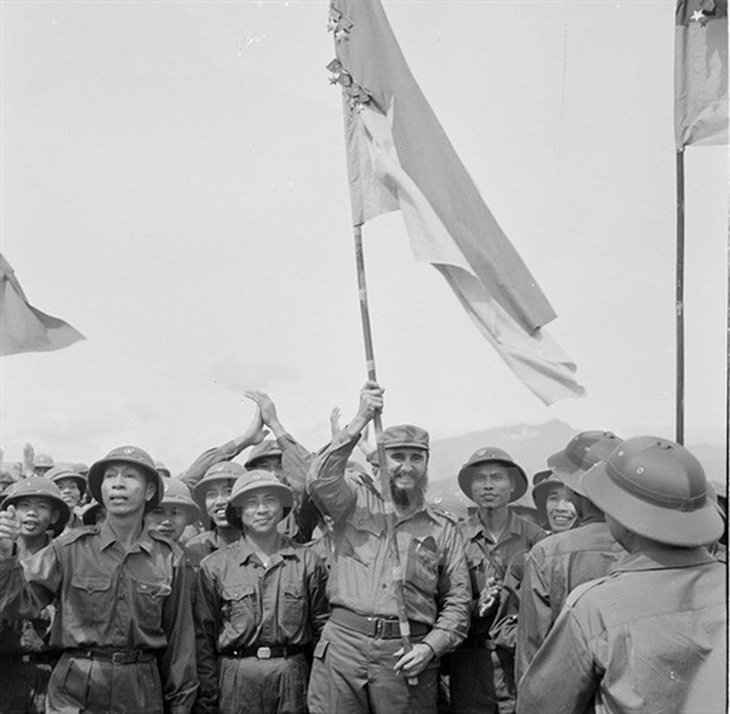 Lãnh tụ Cuba Fidel Castro phất cao lá cờ bách chiến bách thắng lấp lánh huân chương của đoàn Khe Sanh, Quân giải phóng Trị Thiên Huế, tháng 9-1973 - Ảnh: TTXVN