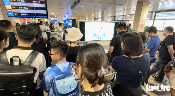 Nhiều hành khách chờ khá lâu mới nhận được hành lý tại dãy băng chuyền ga quốc nội Tân Sơn Nhất - Ảnh: CÔNG TRUNG