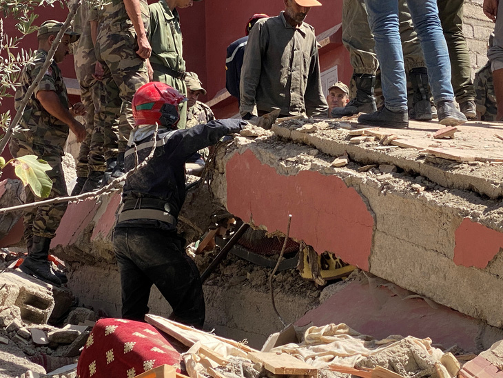 Lực lượng cứu hộ Morocco tìm kiếm người bên dưới đống đổ nát ở thị trấn Amizmiz ngày 9-9 - Ảnh: REUTERS