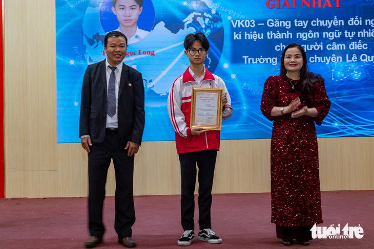 Em Trần Ngọc Long nhận giải nhất cho dự án găng tay chuyển đổi ngôn ngữ ký hiệu - Ảnh: HOÀNG TÁO