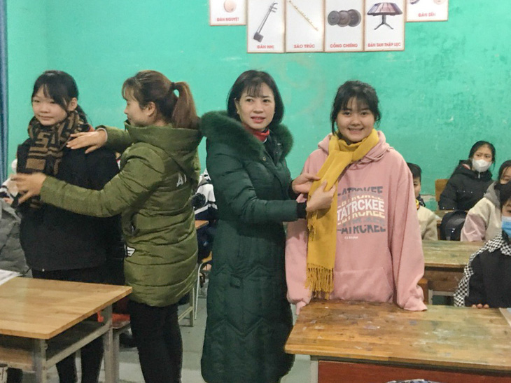 Giáo viên Trường THCS Tân Mộc, Lục Ngạn, Bắc Giang hướng dẫn học sinh cách giữ ấm cơ thể trong rét hại - Ảnh: MINH THU