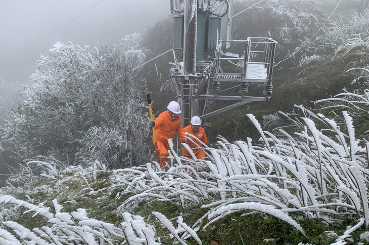 Công nhân ngành điện ở Lạng Sơn vượt băng giá để kiểm tra lưới điện - Ảnh: ANH TUẤN