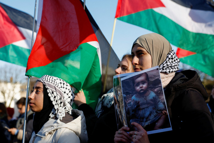 Những người ủng hộ người Palestine theo dõi phiên tòa bên ngoài trụ sở ICJ ngày 26-1 - Ảnh: REUTERS