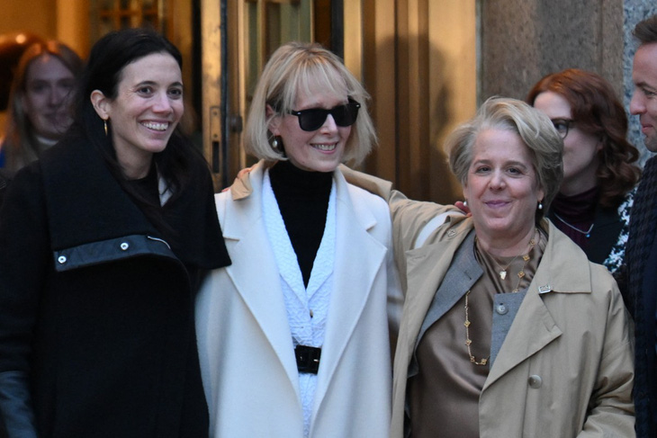 Bà E. Jean Carroll vui mừng rời phiên tòa kiện ông Trump ở Manhattan ngày 26-1 trong vòng tay chào đón của các luật sư - Ảnh: AFP