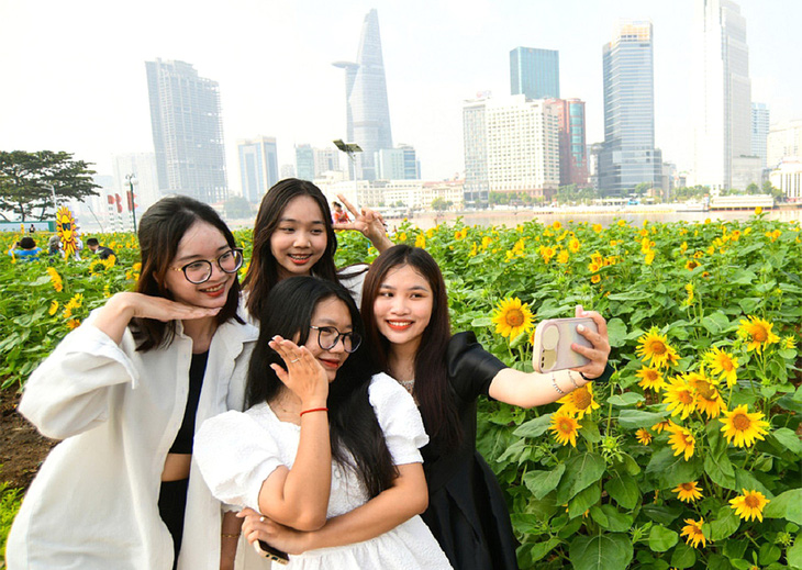 Các bạn trẻ TP.HCM hào hứng chụp ảnh cùng điểm vui xuân mới tại công viên bờ sông Sài Gòn (TP Thủ Đức) - Ảnh: Q.ĐỊNH