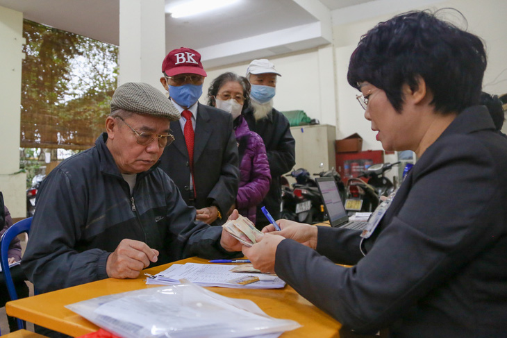 Người dân nhận lương hưu tại một điểm chi trả do nhân viên bưu điện phụ trách ở Hà Nội - Ảnh: HÀ QUÂN
