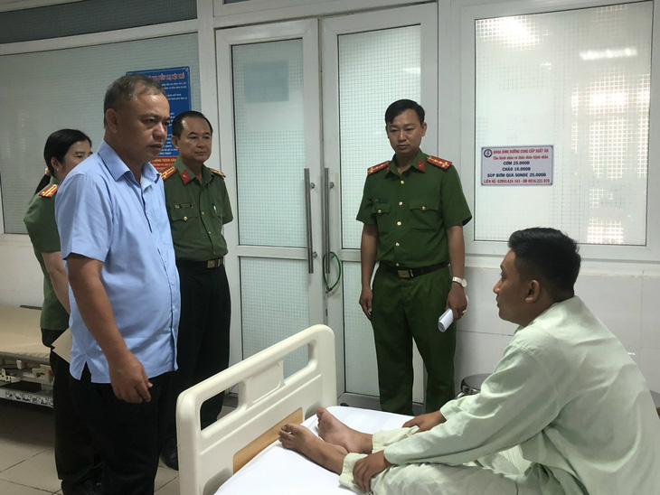 Đại tá Bùi Quốc Khánh - giám đốc Công an tỉnh Sóc Trăng - thăm hỏi động viên chiến sĩ bị thương - Ảnh: Công an cung cấp