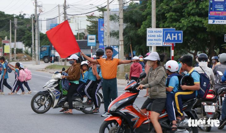 Vụ 'Thầy cô giáo ra quốc lộ 1 cầm cờ 'xin đường' cho học sinh': Nên lắp đèn tín hiệu giao thông - Ảnh 1.