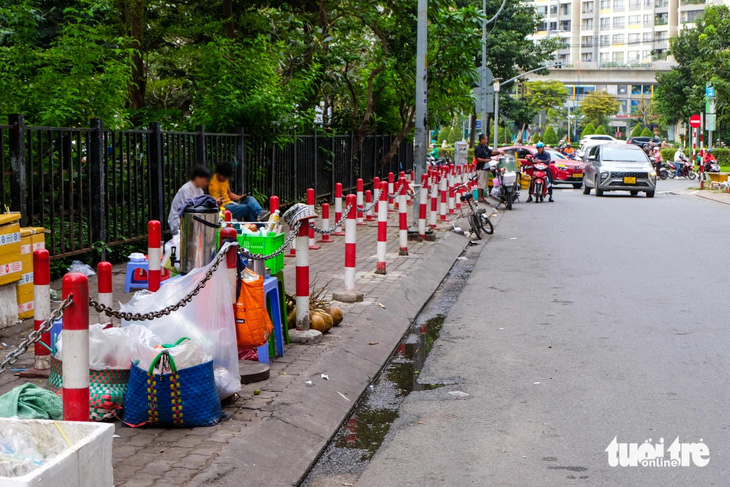 Rào chắn vỉa hè quanh tòa nhà ngăn hàng rong， hàng rong vẫn bán， người đi bộ phải xuống lòng đường - Ảnh 2.