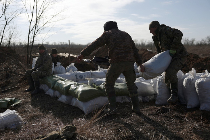 Quân nhân Ukraine chất các túi đất để xây công sự cách không xa thành phố Avdiivka ở khu vực Donetsk, đông Ukraine, hôm 17-2 - Ảnh: AFP