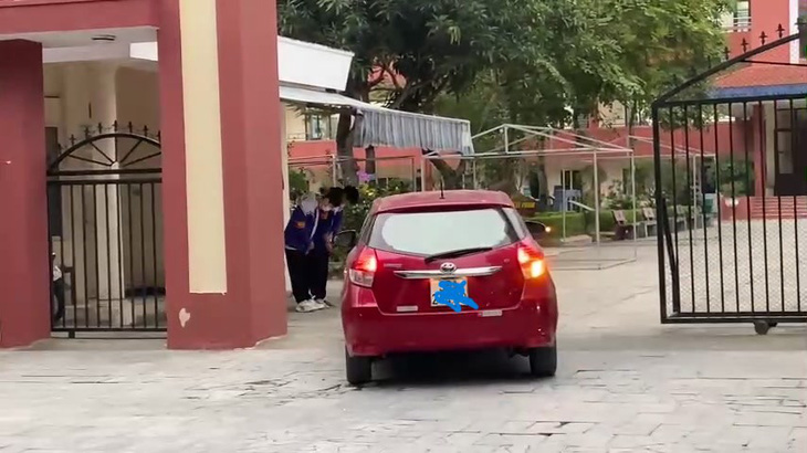 Hình ảnh hai học sinh cúi chào khi ô tô đi vào cổng Trường THCS Trần Mai Ninh, TP Thanh Hóa - Ảnh cắt từ clip trên mạng xã hội