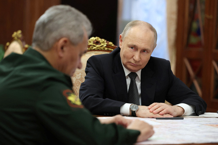 Tổng thống Nga Vladimir Putin (phải) lắng nghe Bộ trưởng Quốc phòng Sergei Shoigu trong cuộc gặp ở Matxcơva, Nga, ngày 20-2 - Ảnh: REUTERS