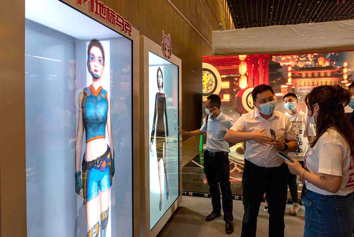 Khách tham quan xem các hình đại diện (avatar) kỹ thuật số tương tác trong Hội chợ thương mại dịch vụ quốc tế Trung Quốc (CIFTIS) năm 2022 ở Bắc Kinh - Ảnh: CHINA DAILY