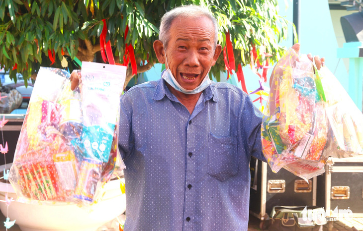 Ông Lê Văn Mười (72 tuổi, ngụ huyện Phú Hòa, tỉnh Phú Yên) vui mừng khi nhận được quà Tết từ gian hàng 0 đồng - Ảnh: NGUYỄN HOÀNG