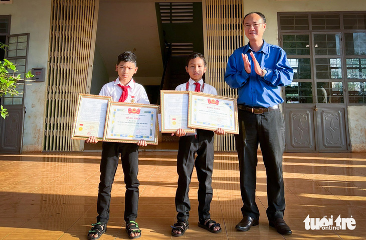 Trao huy hiệu Tuổi trẻ dũng cảm cho em Kpuih Sân (lớp 7C) và Kpuih Dấu (lớp 6A), Trường THCS Kpă Klơng - Ảnh: TẤN LỰC 