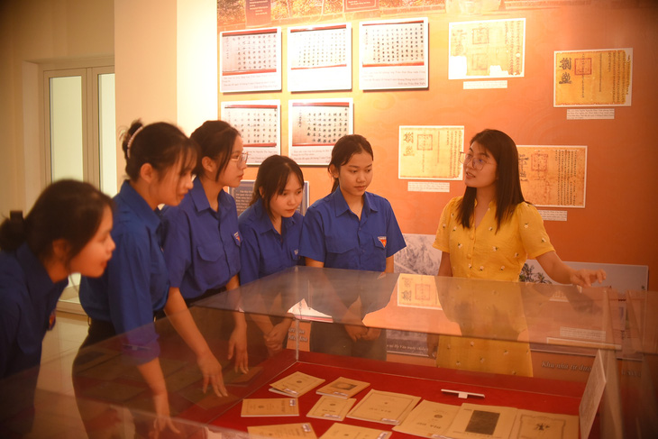 Các bạn trẻ đến xem triển lãm "Sự hình thành chữ quốc ngữ tại Bình Định" - Ảnh: LÂM THIÊN