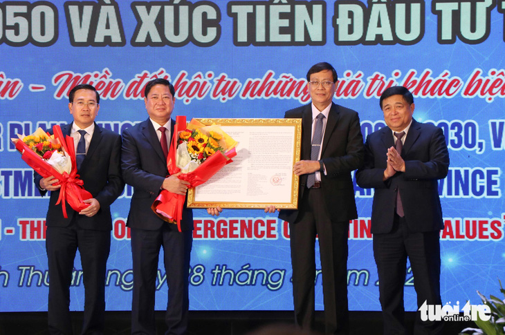 Bộ trưởng Bộ Kế hoạch và Đầu tư Nguyễn Chí Dũng (bìa phải) trao quyết định của Thủ tướng về phê duyệt quy hoạch tỉnh Ninh Thuận thời kỳ 2021 - 2030, tầm nhìn đến năm 2050 - Ảnh: DUY NGỌC